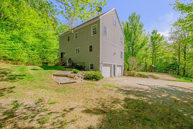 9 Eisenhower Ct, Naples, ME 04055 - rear view of property featuring an attached garage and driveway