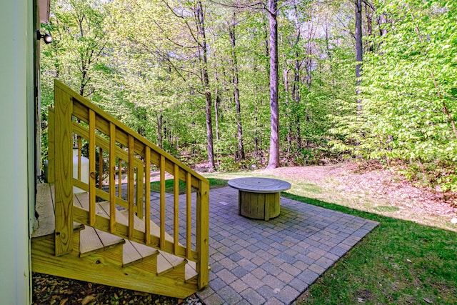 9 Eisenhower Ct, Naples, ME 04055 - view of patio / terrace with a fire pit, stairs, a view of trees, and a wooden deck