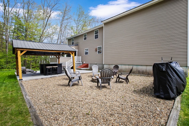 view of yard featuring a gazebo, a patio, and a fire pit