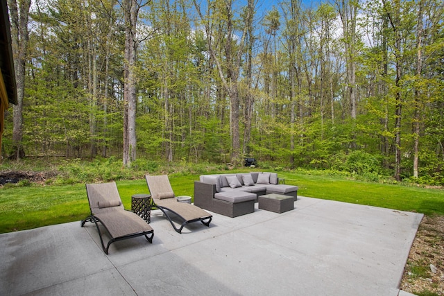 view of patio featuring an outdoor living space and a forest view