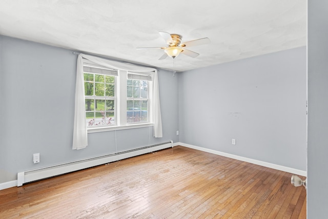unfurnished room featuring baseboard heating, ceiling fan, hardwood / wood-style floors, and baseboards