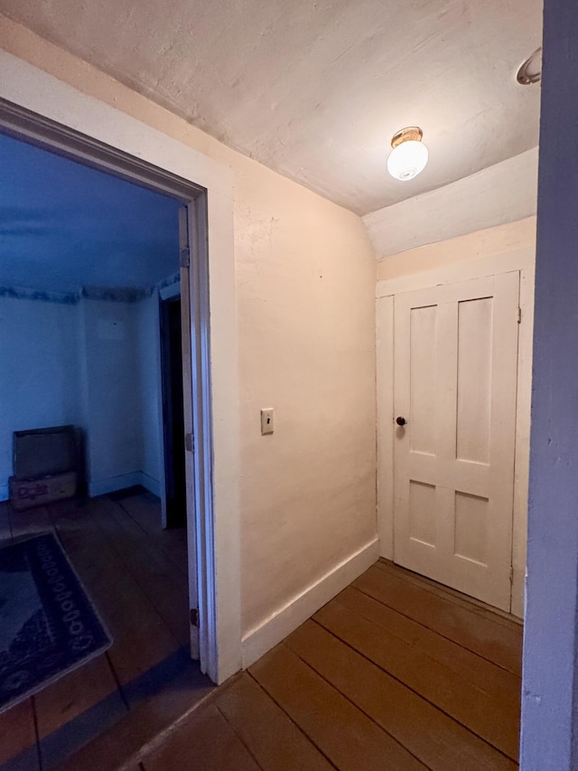 4 Main St, Saint Albans, ME 04971 - hall featuring lofted ceiling, dark wood finished floors, and baseboards