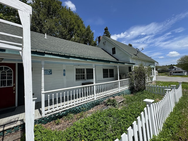 4 Main St, Saint Albans, ME 04971 - view of side of home featuring a porch, fence, and a shingled roof