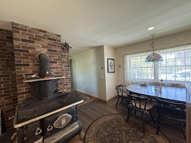 4 Main St, Saint Albans, ME 04971 - dining space featuring a wood stove, baseboards, and wood finished floors
