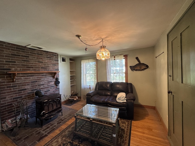 4 Main St, Saint Albans, ME 04971 - living area featuring light wood-style flooring, a wood stove, and baseboards