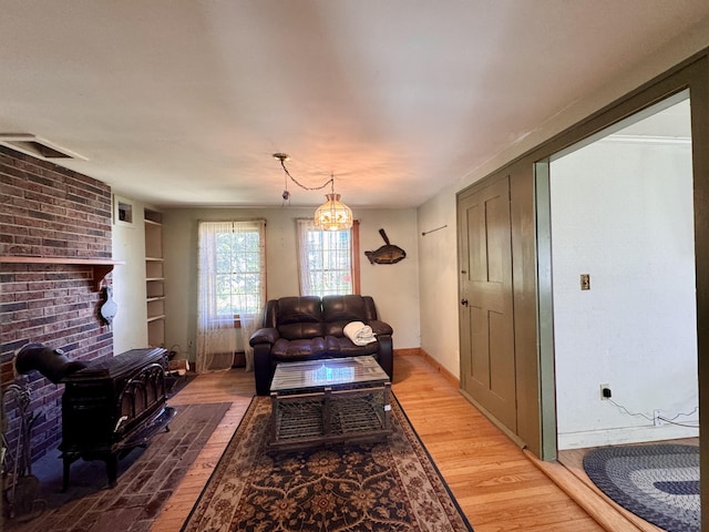 4 Main St, Saint Albans, ME 04971 - living room featuring light wood-style flooring, built in shelves, baseboards, and a chandelier
