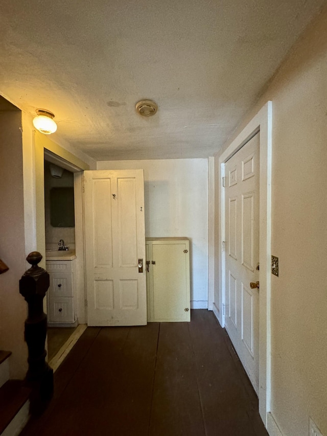 4 Main St, Saint Albans, ME 04971 - corridor featuring a textured ceiling, a sink, and baseboards