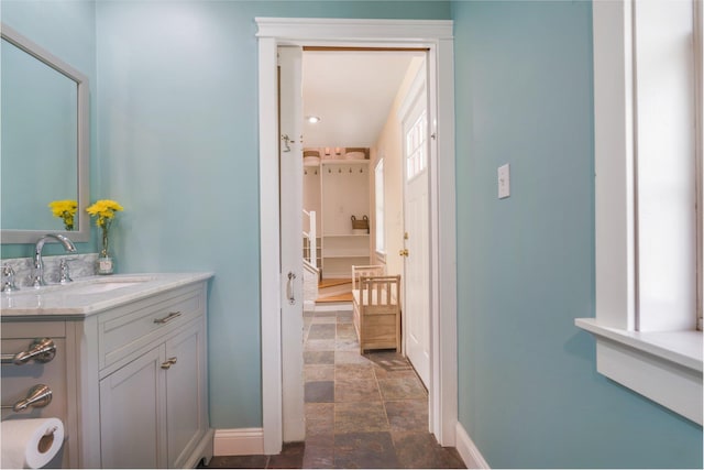 603 S Freedom Rd, Albion, ME 04910 - bathroom with stone finish floors, vanity, and baseboards
