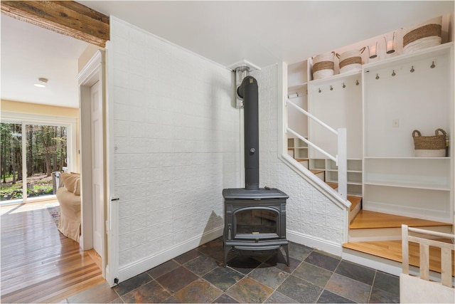 603 S Freedom Rd, Albion, ME 04910 - unfurnished living room with a wood stove, stairway, and baseboards