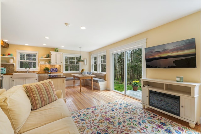 603 S Freedom Rd, Albion, ME 04910 - living room with healthy amount of natural light, light wood finished floors, recessed lighting, and a glass covered fireplace