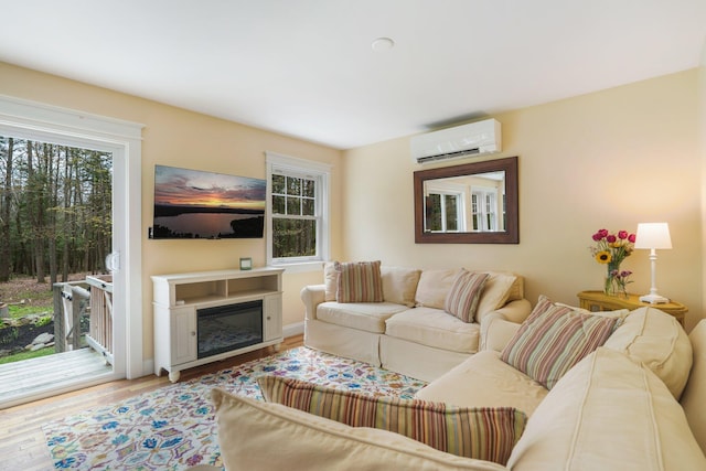 603 S Freedom Rd, Albion, ME 04910 - living room featuring a wall mounted AC and wood finished floors