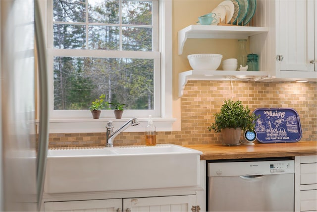 603 S Freedom Rd, Albion, ME 04910 - kitchen featuring stainless steel dishwasher, open shelves, butcher block counters, tasteful backsplash, and a sink