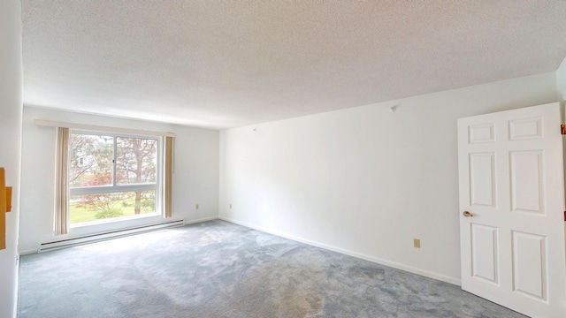 215 E Grand Ave Unit 210, Old Orchard Beach, ME 04064 - carpeted spare room featuring a baseboard radiator, a textured ceiling, and baseboards