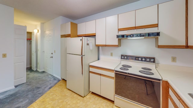 215 E Grand Ave Unit 210, Old Orchard Beach, ME 04064 - kitchen with range with electric stovetop, under cabinet range hood, freestanding refrigerator, light countertops, and light flooring