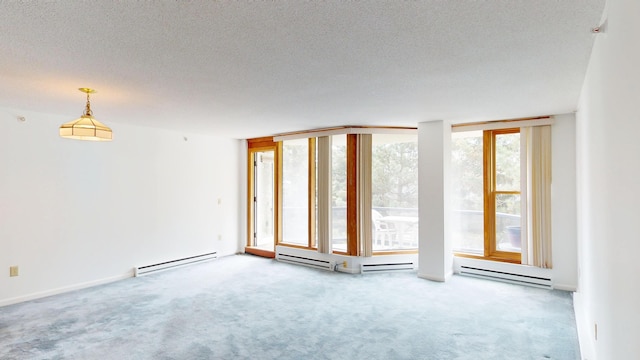 215 E Grand Ave Unit 210, Old Orchard Beach, ME 04064 - carpeted empty room with baseboard heating and a textured ceiling