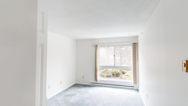 215 E Grand Ave Unit 210, Old Orchard Beach, ME 04064 - spare room featuring a baseboard heating unit, carpet flooring, a textured ceiling, and baseboards