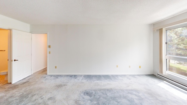 215 E Grand Ave Unit 210, Old Orchard Beach, ME 04064 - carpeted empty room featuring a baseboard heating unit, a textured ceiling, and baseboards