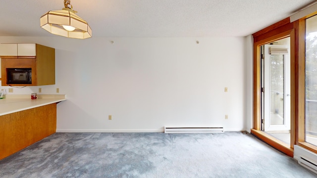 215 E Grand Ave Unit 210, Old Orchard Beach, ME 04064 - unfurnished dining area with baseboard heating, carpet floors, and healthy amount of natural light