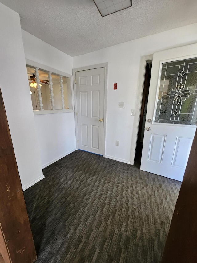 1377 Pushaw Rd, Glenburn, ME 04401 - carpeted foyer entrance featuring a textured ceiling, ceiling fan, and baseboards