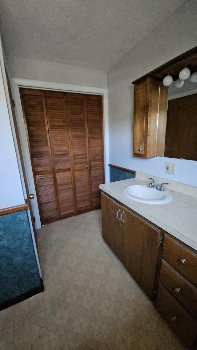 1377 Pushaw Rd, Glenburn, ME 04401 - bathroom featuring tile patterned floors, vanity, and a textured ceiling