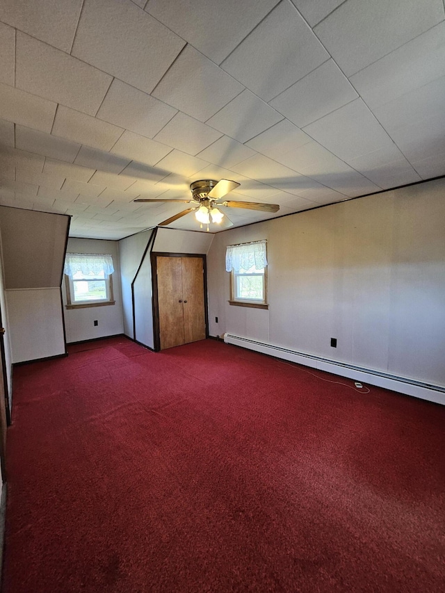 1377 Pushaw Rd, Glenburn, ME 04401 - spare room with dark carpet, plenty of natural light, ceiling fan, and baseboard heating