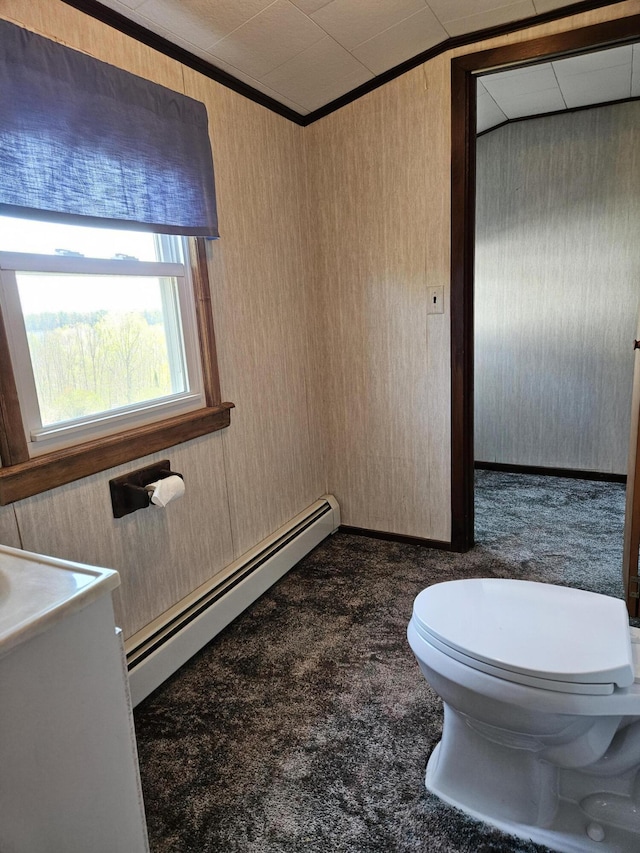 1377 Pushaw Rd, Glenburn, ME 04401 - bathroom featuring a baseboard radiator, toilet, wooden walls, and ornamental molding