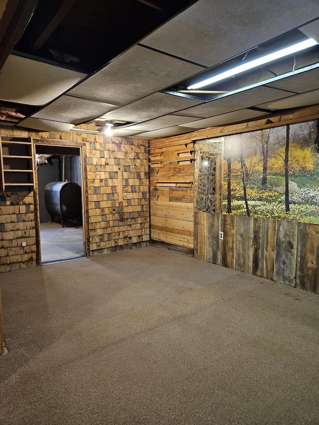 1377 Pushaw Rd, Glenburn, ME 04401 - basement with oil tank, wood walls, and carpet floors
