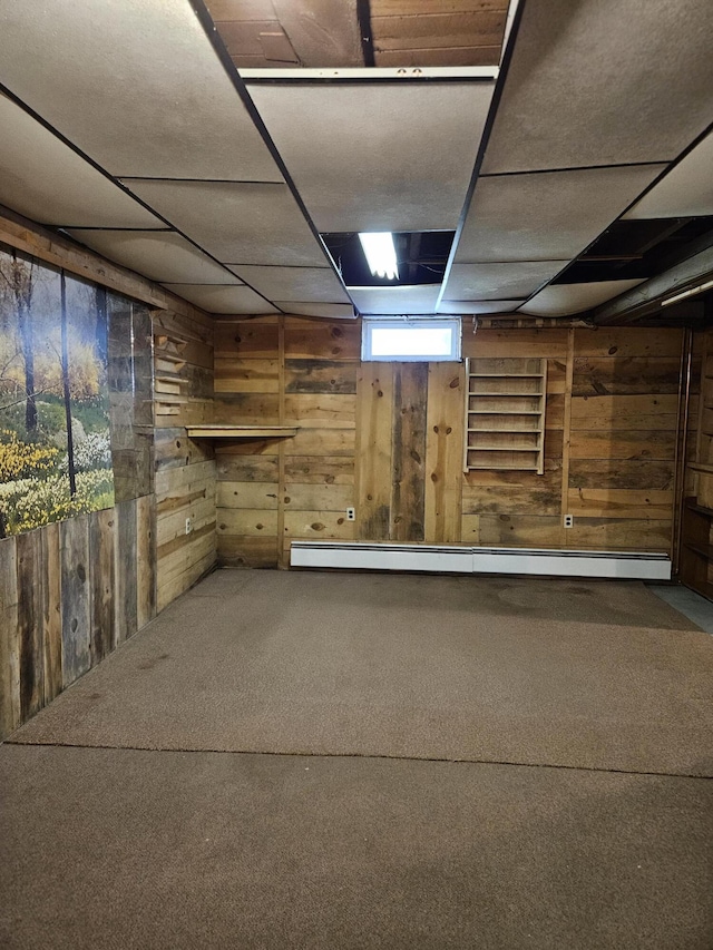 1377 Pushaw Rd, Glenburn, ME 04401 - below grade area with wood walls, carpet flooring, a paneled ceiling, and a baseboard radiator