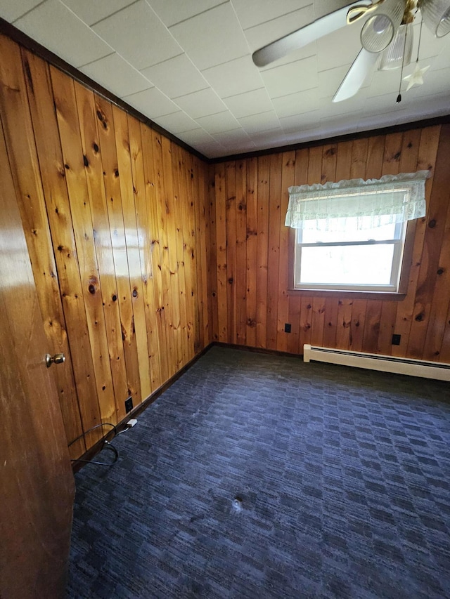 1377 Pushaw Rd, Glenburn, ME 04401 - empty room featuring wood walls, a baseboard radiator, ceiling fan, carpet, and baseboards