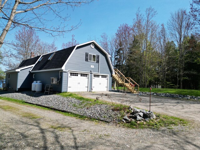 11 Beethoven Ln, Enfield, ME 04493 - view of property exterior featuring a gambrel roof, a chimney, and stairs