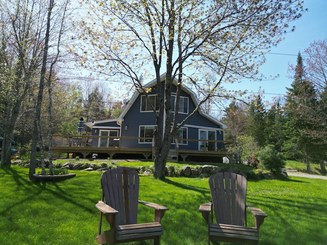 11 Beethoven Ln, Enfield, ME 04493 - back of property with a wooden deck and a lawn