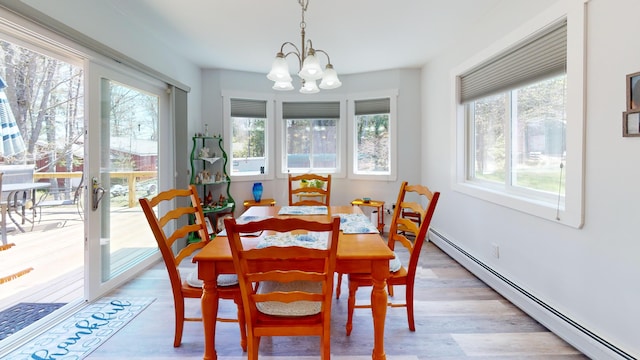11 Beethoven Ln, Enfield, ME 04493 - dining room with baseboard heating, healthy amount of natural light, a chandelier, and light wood-style floors
