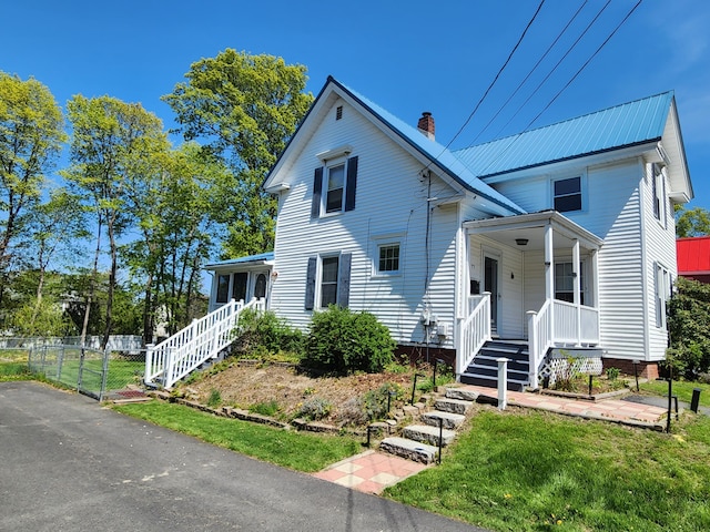 77 Cottage St, Bangor, ME 04401 - view of front of property with covered porch, a chimney, stairway, and a front yard