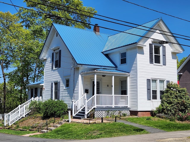 77 Cottage St, Bangor, ME 04401 - view of front of house with a porch, a chimney, metal roof, and stairway