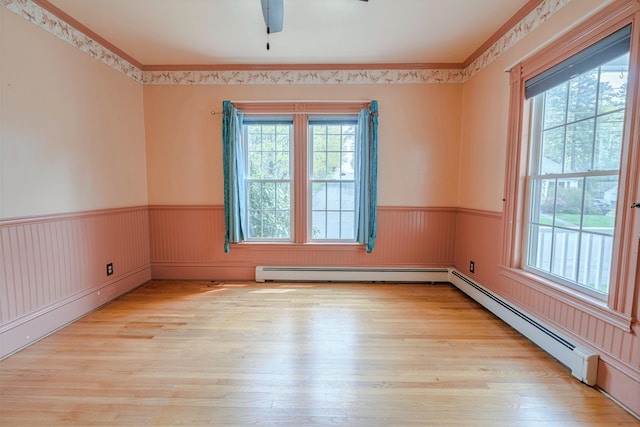 77 Cottage St, Bangor, ME 04401 - spare room with wainscoting, wood finished floors, a baseboard radiator, a ceiling fan, and ornamental molding