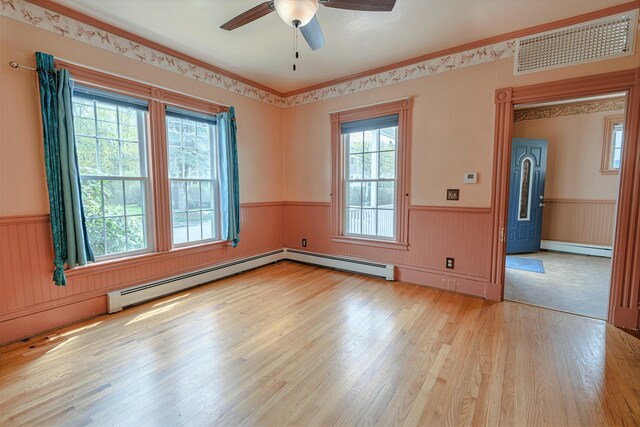 77 Cottage St, Bangor, ME 04401 - spare room with wainscoting, a baseboard radiator, a ceiling fan, and light wood-style flooring