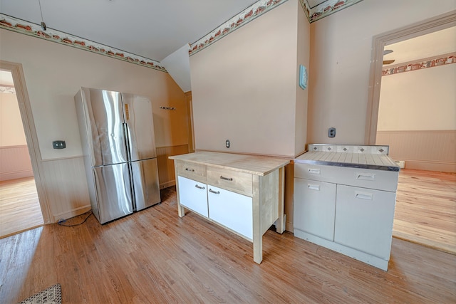 77 Cottage St, Bangor, ME 04401 - kitchen featuring light wood-type flooring, wainscoting, freestanding refrigerator, and light countertops