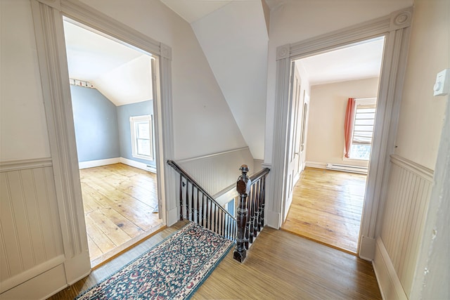 77 Cottage St, Bangor, ME 04401 - stairway with a baseboard heating unit, wood finished floors, vaulted ceiling, and a wainscoted wall
