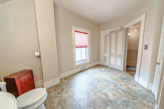 77 Cottage St, Bangor, ME 04401 - unfurnished bedroom with a baseboard heating unit, light stone finish floors, and baseboards