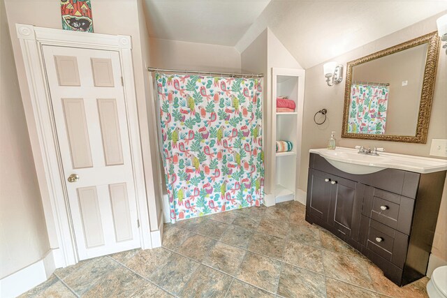 77 Cottage St, Bangor, ME 04401 - bathroom featuring vanity, stone finish flooring, curtained shower, and vaulted ceiling