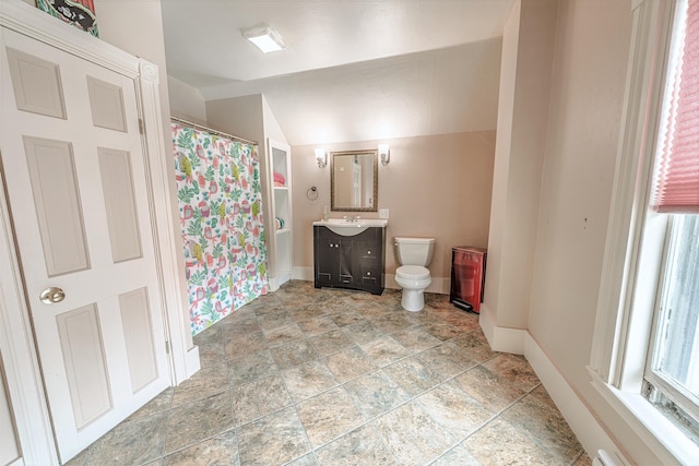 77 Cottage St, Bangor, ME 04401 - full bathroom featuring toilet, baseboards, vanity, stone finish floors, and lofted ceiling