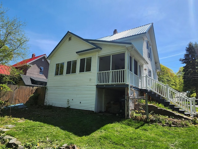 77 Cottage St, Bangor, ME 04401 - back of house featuring stairs, a chimney, a sunroom, and metal roof