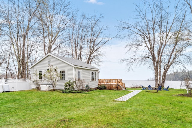 view of yard with a deck with water view