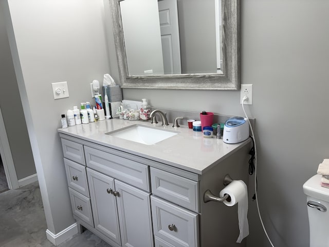 38 Deer Ridge Ln, Windsor, ME 04363 - bathroom featuring vanity, baseboards, toilet, and marble finish floors