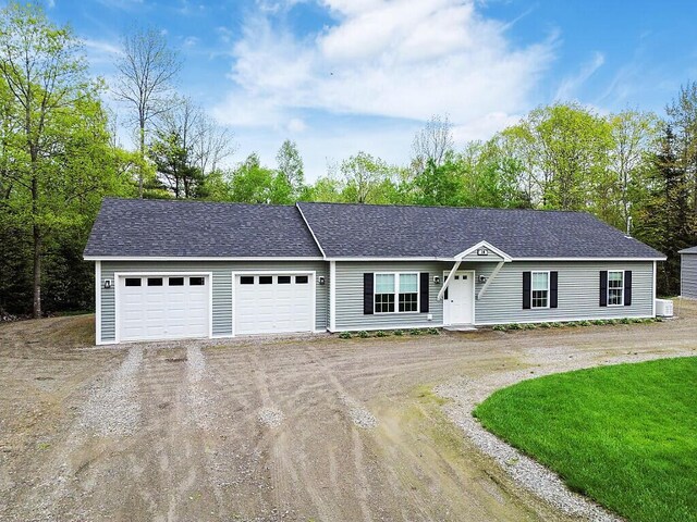 38 Deer Ridge Ln, Windsor, ME 04363 - ranch-style home featuring driveway, a garage, central air condition unit, and a shingled roof