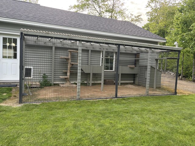 38 Deer Ridge Ln, Windsor, ME 04363 - rear view of house with a shingled roof, an outdoor structure, and a lawn