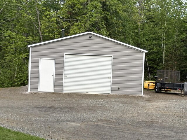 38 Deer Ridge Ln, Windsor, ME 04363 - detached garage with a forest view