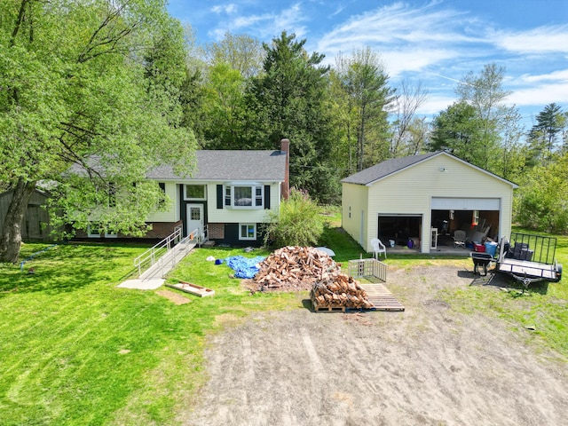 5 Skyline Dr, Chelsea, ME 04330 - bi-level home featuring a detached garage, a chimney, an outdoor structure, and a front lawn
