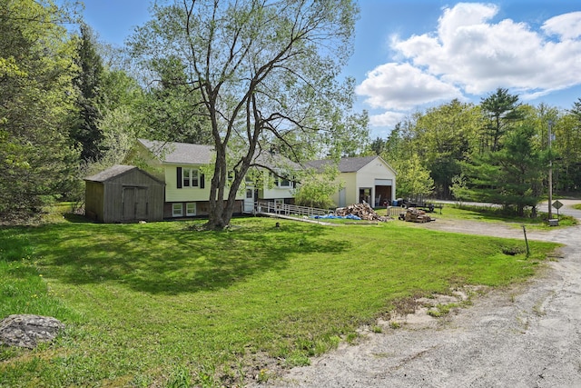 5 Skyline Dr, Chelsea, ME 04330 - view of front of home with driveway, a garage, and a front lawn