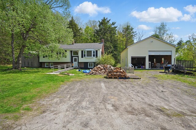 5 Skyline Dr, Chelsea, ME 04330 - view of front facade featuring a garage, a chimney, an outdoor structure, and a front lawn